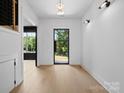 Sunlit foyer with light wood floors and a sleek, modern front door leading to an inviting entrance at 733 Barbary Pl, Lincolnton, NC 28092