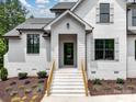 Close up of the home's front entrance featuring a painted brick facade, and wood accents on the stairway at 733 Barbary Pl, Lincolnton, NC 28092