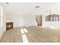 Bright living room with fireplace and light wood laminate floors at 7364 Laurel Valley Rd, Charlotte, NC 28273