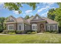 Charming single-story home featuring stone accents, manicured landscaping, and a warm, inviting entrance at 7913 Buena Vista Dr, Denver, NC 28037