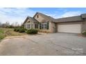 Home with attached garage and stone exterior at 824 Wynnshire Dr # D, Hickory, NC 28601