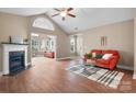 Spacious living room featuring hardwood floors, a cozy fireplace, and an adjoining sunroom at 824 Wynnshire Dr # D, Hickory, NC 28601