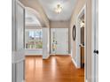 Welcoming foyer with gleaming hardwood floors, an arched doorway and ample natural light at 1016 Filly Dr, Indian Trail, NC 28079