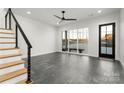Modern living space with gray floors, large windows, and access to the front porch at 108 Isle Of Pines Rd # 3, Mooresville, NC 28117