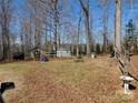 Spacious backyard with sheds and a firepit, offering ample storage and outdoor recreational possibilities at 13062 Highway 55 W Hwy, York, SC 29745