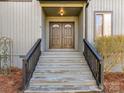 Inviting front entryway featuring double doors with glass inlays and traditional wood banisters at 13424 Portside Ct, Charlotte, NC 28278