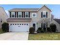Traditional two-story home featuring a well-maintained lawn and attached two-car garage at 1432 Astoria Nw Ln, Concord, NC 28027