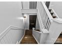 Interior shot of a staircase leading to a door, showcasing classic architectural details at 1517 Cleveland Ave # D, Charlotte, NC 28203