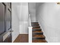 Interior view of a staircase featuring hardwood steps, white banisters, and wainscoting at 1517 Cleveland Ave # D, Charlotte, NC 28203