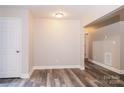 Hallway with gray wood-look floors and neutral paint at 19 Church St, York, SC 29745