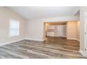 Open-concept living room featuring modern floors and neutral paint, leading into kitchen at 19 Church St, York, SC 29745