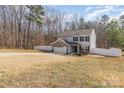 Two-story home with brick garage, gray siding, black shutters, surrounded by a fenced yard and green trees at 205 Athens Dr # 31, Salisbury, NC 28147