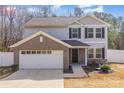 Two-story home with a brick garage, gray siding, black shutters, and a well-maintained front yard at 205 Athens Dr # 31, Salisbury, NC 28147