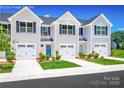 Exterior of townhomes featuring individual garages, well-manicured lawns and beautiful contemporary curb appeal at 2061 Stephens Farm Dr, China Grove, NC 28023