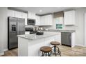 Modern kitchen with white cabinets, stainless steel appliances, granite countertops, and center island with stools at 2061 Stephens Farm Dr, China Grove, NC 28023