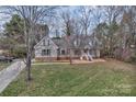 Inviting two-story home featuring a cozy front porch and well-maintained lawn at 2201 Holly Ln, Shelby, NC 28150