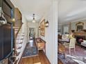 Inviting foyer with hardwood floors, staircase, and view into a cozy living room with fireplace at 227 Perrin Pl, Charlotte, NC 28207