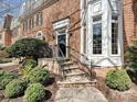 Close-up of a brick house entrance with iron railings and well-maintained landscaping at 227 Perrin Pl, Charlotte, NC 28207