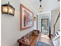 Classic hallway featuring a wooden bench, decorative lighting, and detailed artwork at 227 Perrin Pl, Charlotte, NC 28207