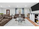 Cozy living room featuring hardwood floors, stylish sofas, and an entertainment center at 24253 Old Aquadale Rd, Albemarle, NC 28001