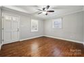 Bright bedroom with hardwood floors, a ceiling fan, and two windows, offering a peaceful retreat at 259 Unionville Indian Trail W Rd, Indian Trail, NC 28079