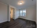 Well-lit bedroom with dark wood flooring and a bright window offering a pleasant view at 283 Luray Way # 449, Rock Hill, SC 29730