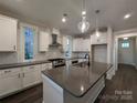 Modern kitchen with white cabinets, stainless steel appliances, and a large center island with a sink at 283 Luray Way # 449, Rock Hill, SC 29730