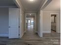 Bright hallway with light wood-look floors and white trim, leading to other rooms in the home at 287 Luray Way # 450, Rock Hill, SC 29730