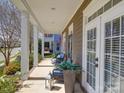 Inviting front porch featuring elegant columns, neutral tones, and outdoor seating at 371 Montibello Dr, Mooresville, NC 28117