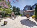 Backyard patio offers an outdoor fireplace, seating area, and manicured landscaping at 371 Montibello Dr, Mooresville, NC 28117