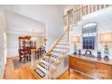 Elegant foyer with hardwood floors, staircase, decorative mirror, and stylish furnishings leading to a formal dining room at 3716 Drayton Hall Ln, Charlotte, NC 28270