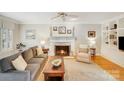 Comfortable living room with fireplace, neutral decor, plush seating, and bright natural light, ideal for relaxing at 3716 Drayton Hall Ln, Charlotte, NC 28270