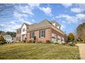 Side view of a brick home with an attached garage and mature trees at 4421 3Rd Nw St, Hickory, NC 28601