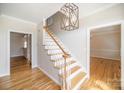 Foyer featuring wood floors, staircase, and light fixture at 4421 3Rd Nw St, Hickory, NC 28601
