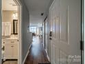 Hallway view to the Living Room, with the bathroom to the left, and coat closet to the right at 513 N Graham St # 3H, Charlotte, NC 28202