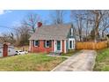 Quaint two-story home featuring a brick facade, gray roof, and well-kept lawn at 514 3Rd Avenue Se Dr, Hickory, NC 28602