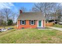 Inviting two-story home with a brick facade, lush green lawn, and well-manicured landscaping at 514 3Rd Avenue Se Dr, Hickory, NC 28602