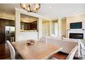 Inviting living room with a modern light fixture, open to the kitchen and with view of the fireplace at 5425 Closeburn Rd # 309, Charlotte, NC 28210