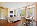 Bright living room boasts large windows, fireplace, hardwood floors and comfortable seating area at 5425 Closeburn Rd # 309, Charlotte, NC 28210