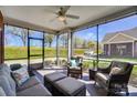 Comfortable screened-in porch with ample seating, offering a relaxing view of the surrounding landscape at 8146 Viscount Ct, Denver, NC 28037