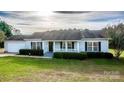 Charming single-story home with manicured lawn, inviting front porch, and attached garage at 9450 Paul Payne Store Rd, Stony Point, NC 28678