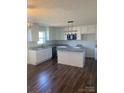Modern kitchen with white cabinetry, granite countertops and hardwood flooring at 9450 Paul Payne Store Rd, Stony Point, NC 28678