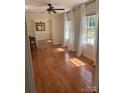 Bright living room with hardwood floors, large windows, and double doors leading to the dining room at 100 Chadmore Dr, Charlotte, NC 28270