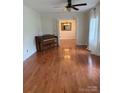 Spacious living room featuring hardwood floors, a piano, and lots of natural light at 100 Chadmore Dr, Charlotte, NC 28270