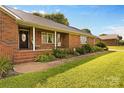 Charming front porch with brick accents and space for outdoor seating at 105 Baymount Dr, Statesville, NC 28625