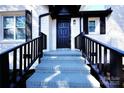 A covered porch with black railings leads to the dark-colored front door at 106 Easy St, Concord, NC 28027