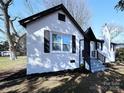 Side view of renovated brick home featuring black trim and well maintained landscaping at 106 Easy St, Concord, NC 28027