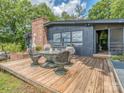 Outdoor seating area with table, umbrella, and four chairs on a wooden deck at 109 Joe Teague Rd, Hickory, NC 28601