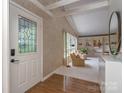 Bright living room featuring a large window, built-in shelving, and hardwood floors at 109 Joe Teague Rd, Hickory, NC 28601
