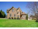 Charming two-story home with a well-maintained lawn and mature tree, set in a desirable location at 1125 Bugle Ln, Newton, NC 28658